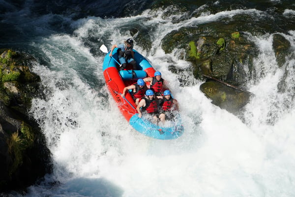 Raft going over a drop on whitewater rapids